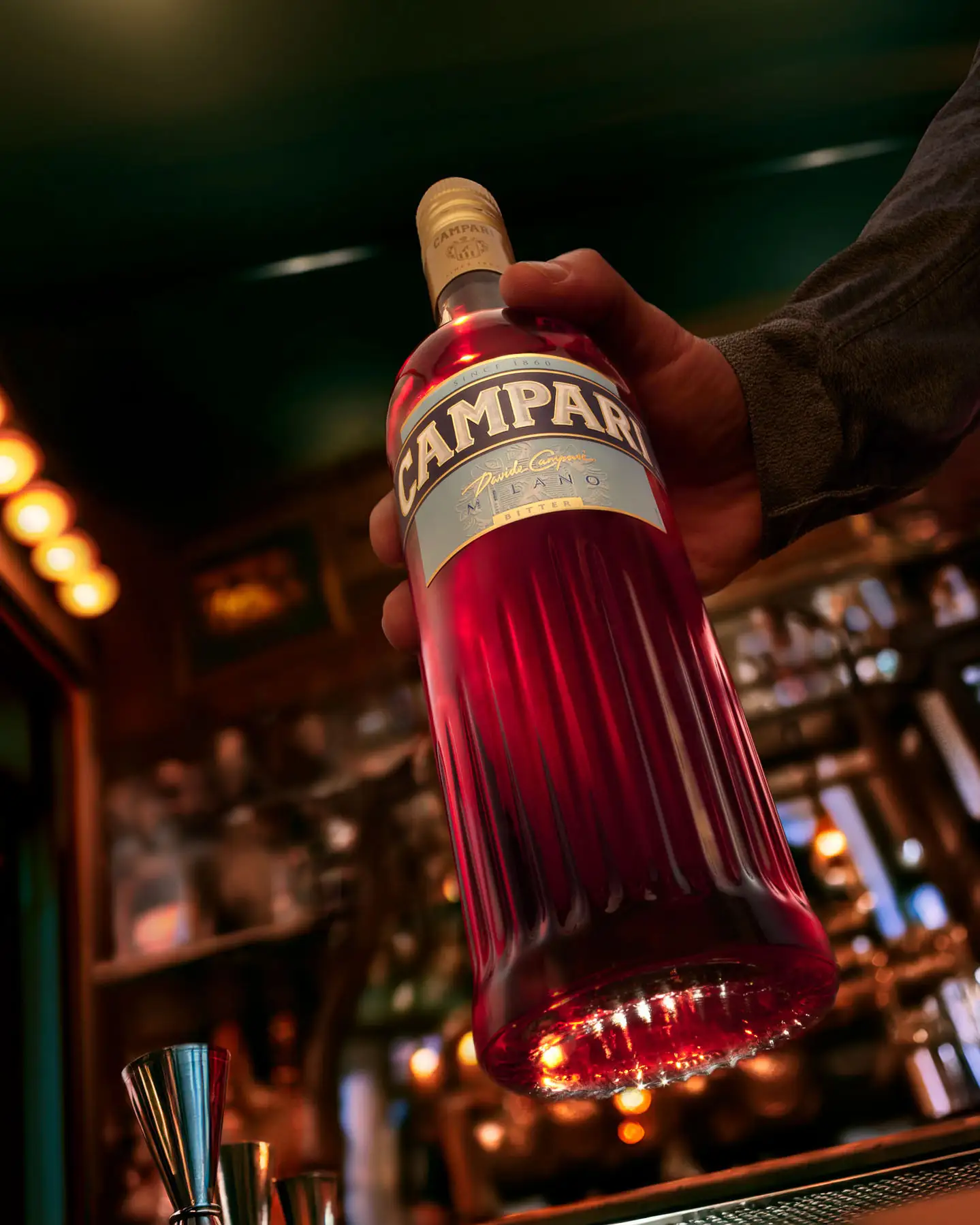 Campari bottle and glass styled against gloss-red redesign set