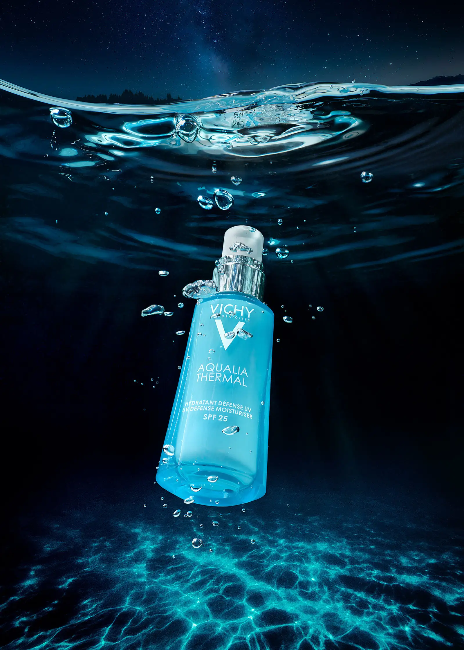 Vichy Aqualia Thermal serum bottle suspended in cooling water droplets