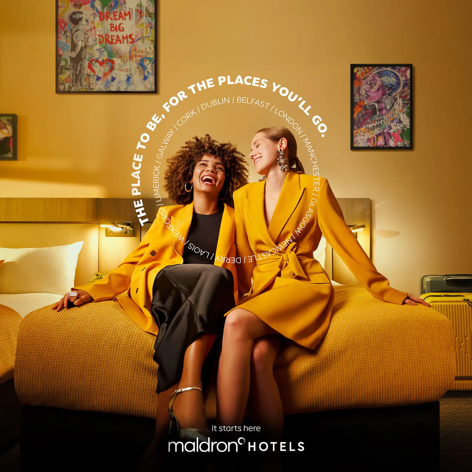 Friends toasting cocktails in Maldron Hotel suite with city backdrop